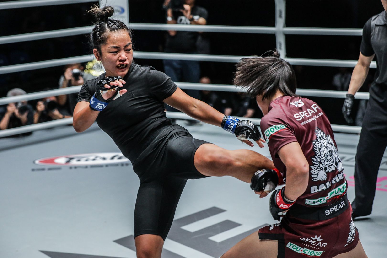 Vietnamese-American Bi Nguyen lands a kick on Myanmar martial arts star Bozhena Antoniyar